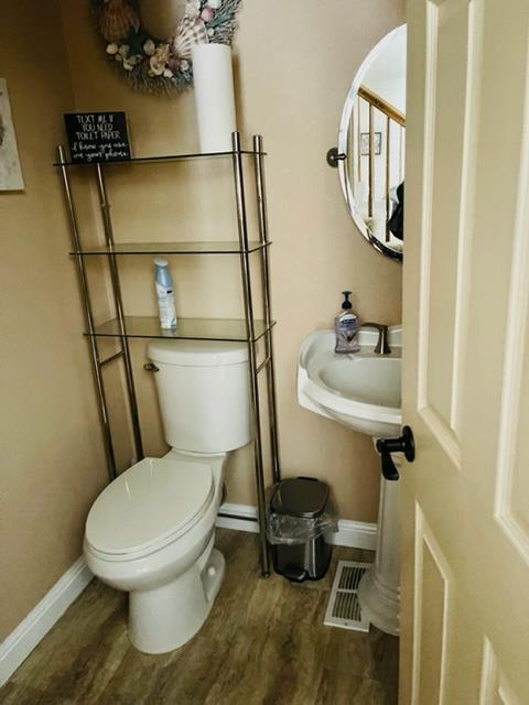 7691 Church Street, Unit B Gilroy, CA 95020 - Photo 4 of 9 a white toilet sitting next to a bathroom sink and a mirror