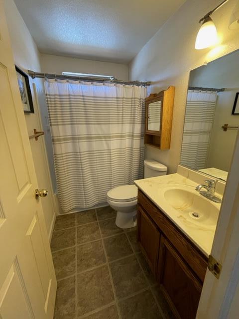 7691 Church Street, Unit B Gilroy, CA 95020 - Photo 7 of 9 a bathroom with a sink a toilet a mirror a vanity and shower