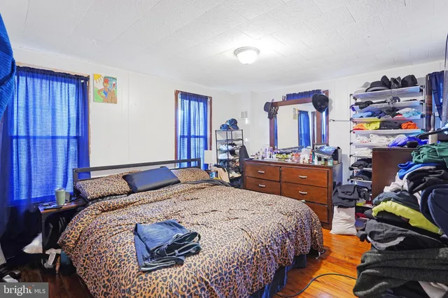 a bed sitting in a bedroom next to a window