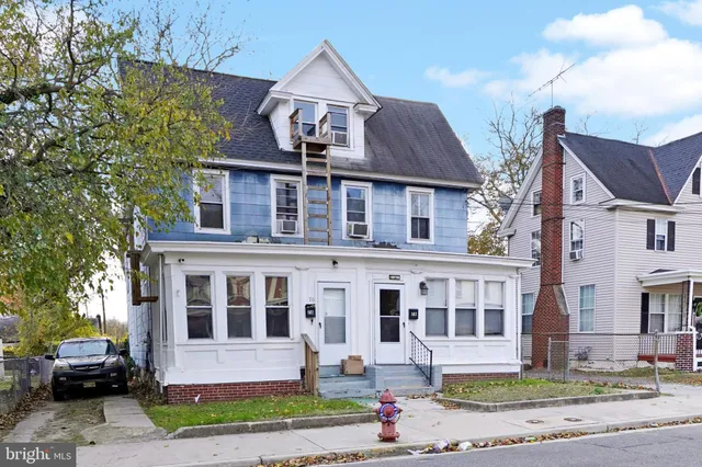 a front view of a residential apartment building with a yard