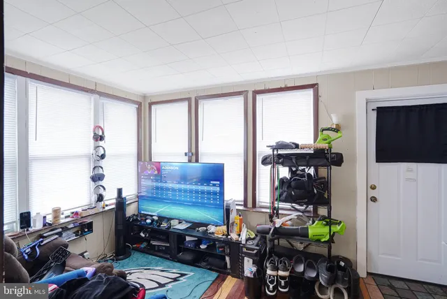 a room with furniture a flat screen tv and a window