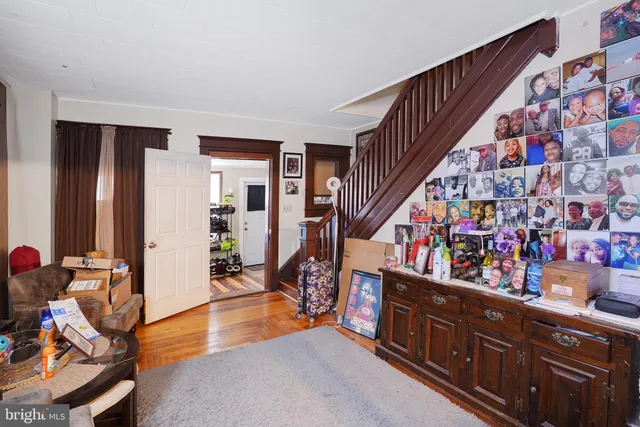 a living room with lots of furniture and stairs