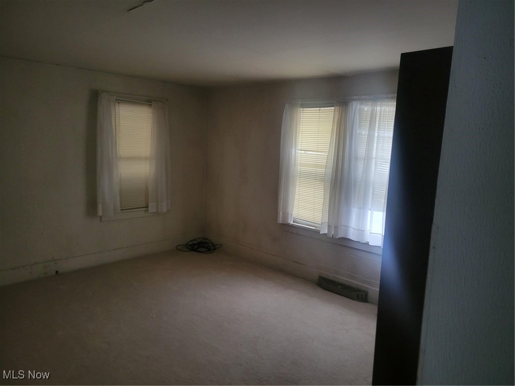 7631 Mines Road Southeast Warren, OH 44484 - Photo 5 of 22 Unfurnished room featuring healthy amount of natural light and carpet flooring