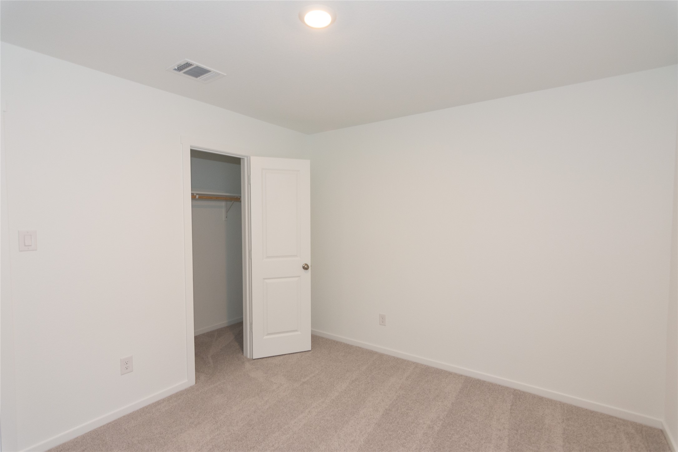 153 Star Packer Lane Jarrell, TX 76537 - Photo 16 of 30 A well-lit bedroom offering a blank canvas for personalization.