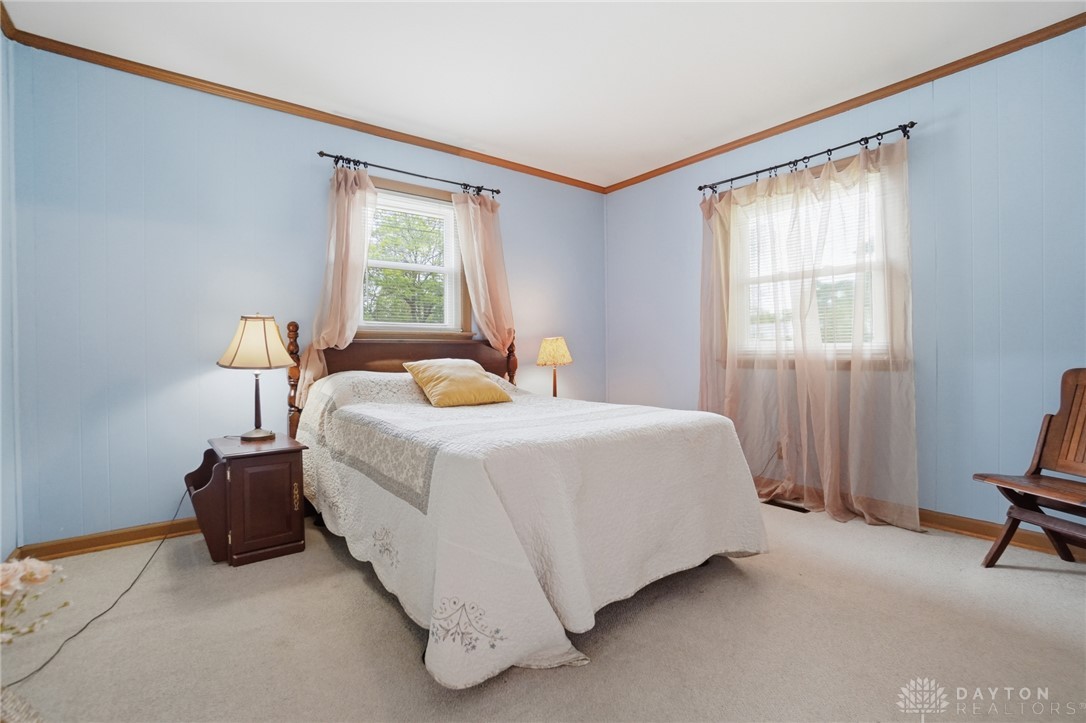 6119 Flemington Road Dayton, OH 45459 - Photo 31 of 76 This inviting room features soft blue paneling and light-filled windows, creating a serene and comfortable living space.