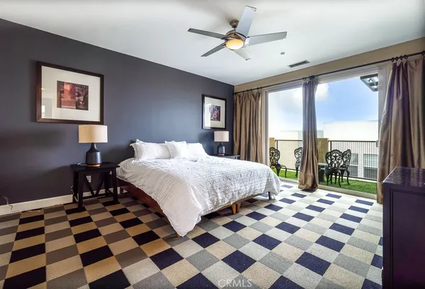 a bedroom with a bed and a mirror