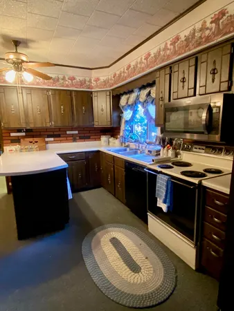 a kitchen with a sink appliances and cabinets