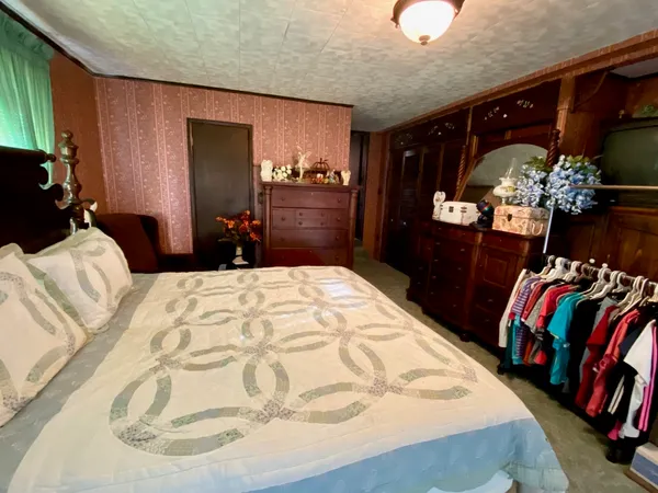 a bed sitting in a bedroom next to a window