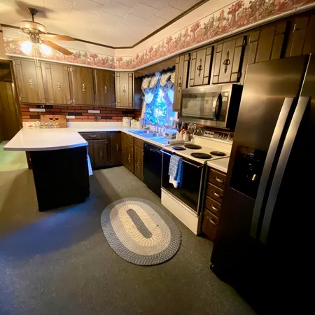 a kitchen with a stove a sink and a refrigerator