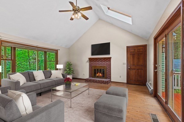 7 Ohio Road Tyngsboro, MA 01879 - Photo 3 of 35 a living room with furniture a fireplace and a floor to ceiling window