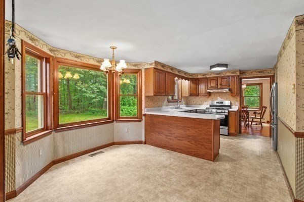7 Ohio Road Tyngsboro, MA 01879 - Photo 10 of 35 a large kitchen with kitchen island granite countertop a large window and a counter space