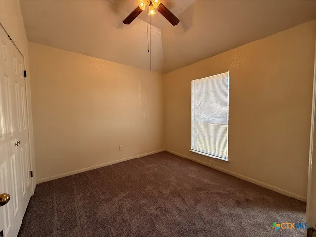 an empty room with a empty space and a ceiling fan