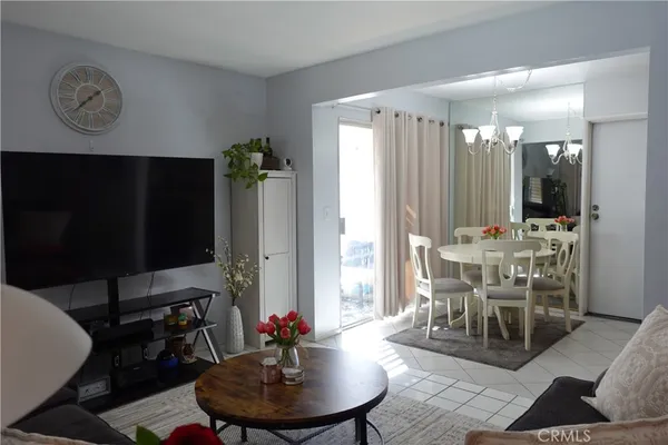 a dining room with furniture and a large window