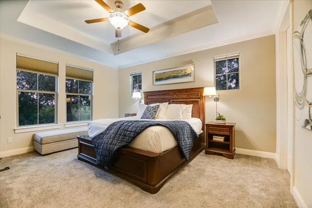 a bedroom with a bed and a large window