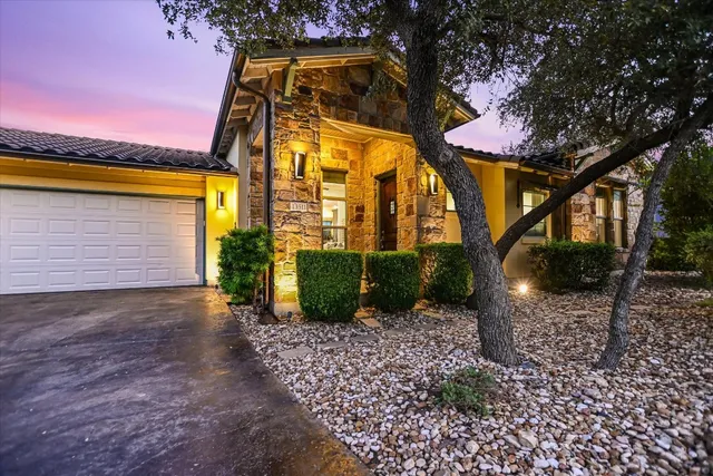 a view of a house with a backyard