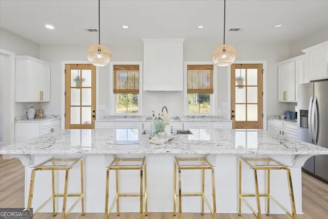 a kitchen with stainless steel appliances granite countertop a kitchen island hardwood floor sink stove and granite counter tops