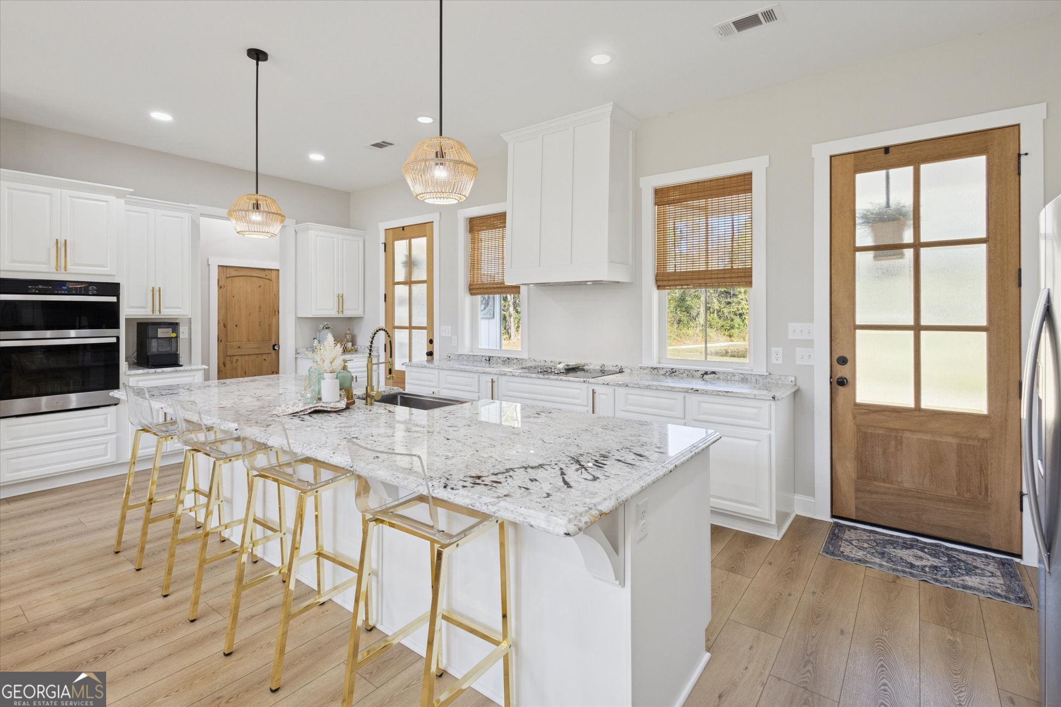 4031 Mud Road Brooklet, GA 30415 - Photo 15 of 49 a kitchen with granite countertop a stove a sink a center island a refrigerator and a wooden floor