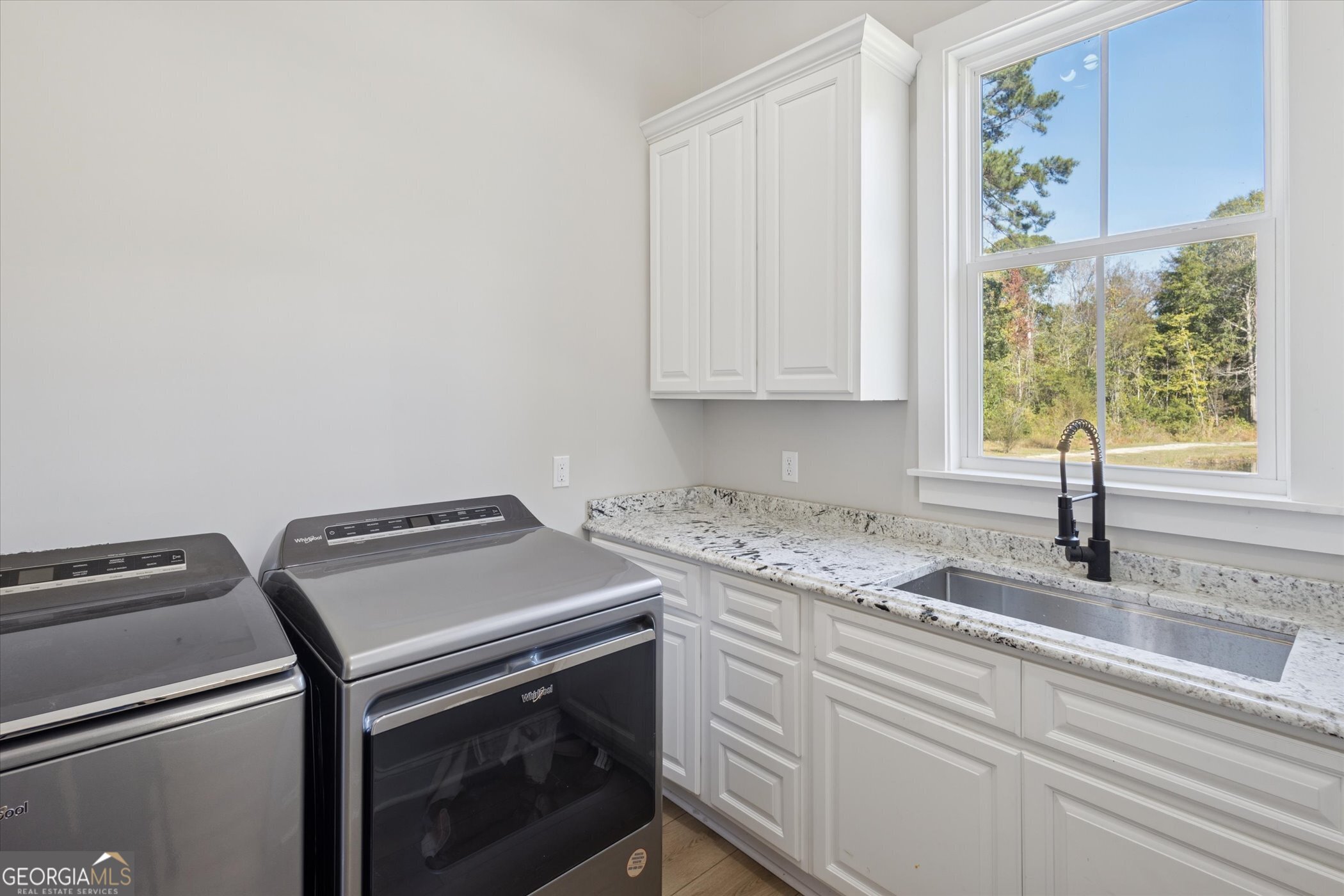 4031 Mud Road Brooklet, GA 30415 - Photo 24 of 49 a kitchen with granite countertop a sink a stove and cabinets