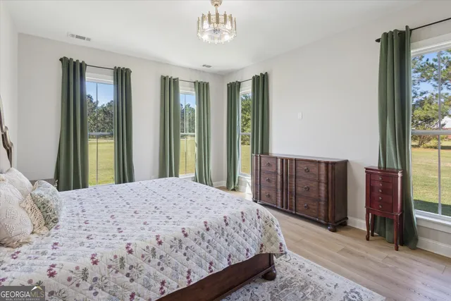 a bedroom with a large bed and a dresser