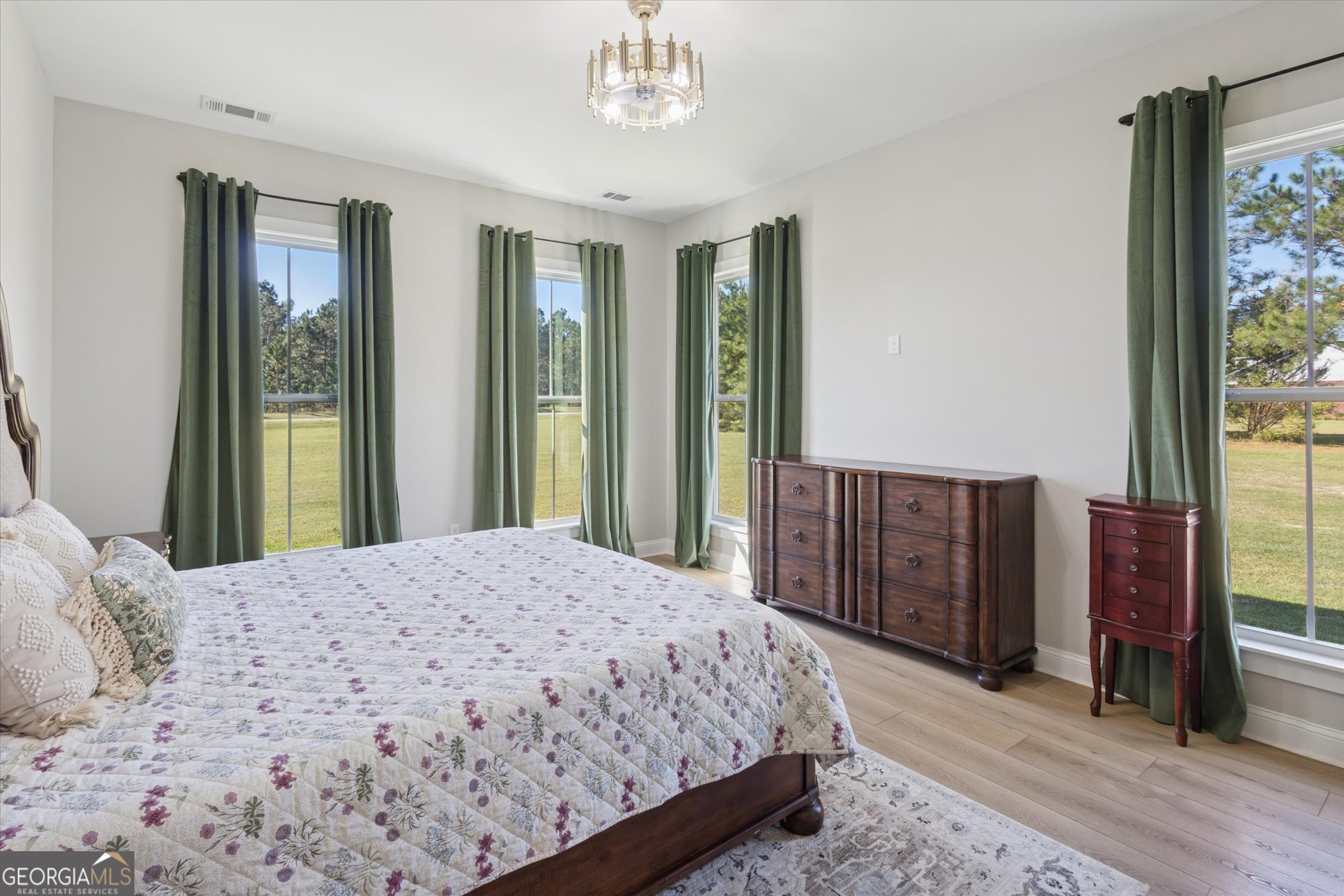 4031 Mud Road Brooklet, GA 30415 - Photo 26 of 49 a bedroom with a large bed and a dresser