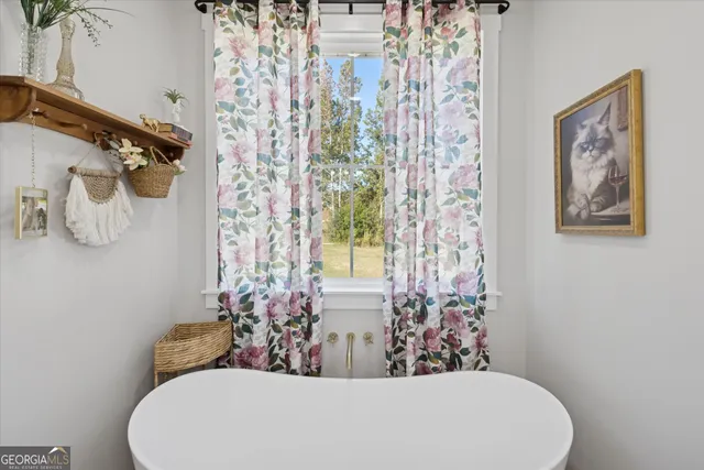 a white bath tub sitting next to a white toilet