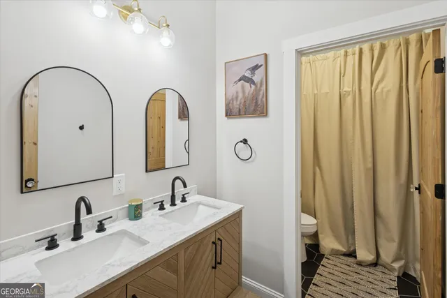 a bathroom with a double vanity sink and a mirror