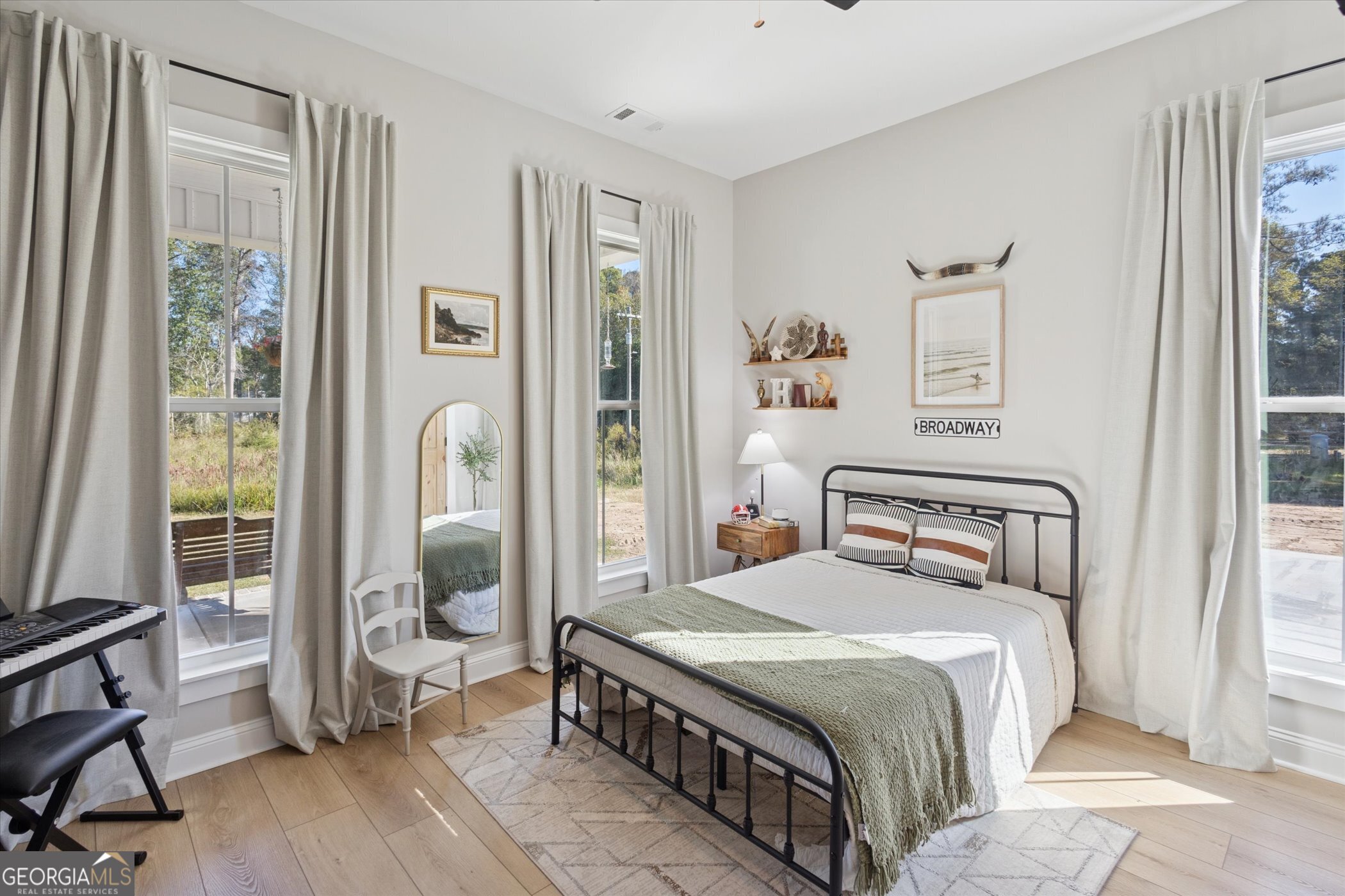 4031 Mud Road Brooklet, GA 30415 - Photo 35 of 49 a bedroom with a bed a mirror and a window