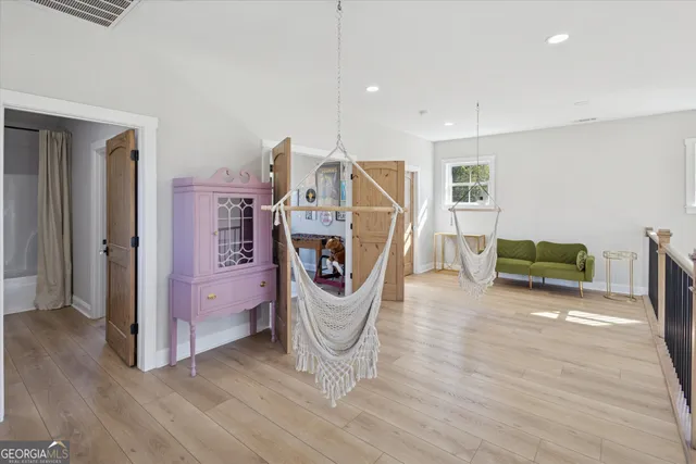 a view of a livingroom with furniture and an empty room