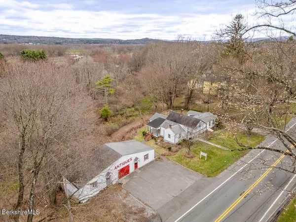 an aerial view of a house with a garden and lake view