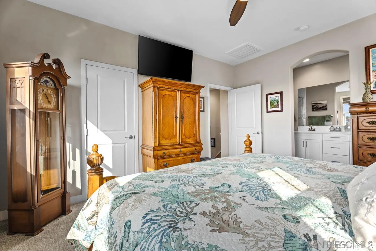4326 Star Path Way, Unit 1 Oceanside, CA 92056 - Photo 28 of 46 a bedroom with a bed and a flat tv screen on dresser