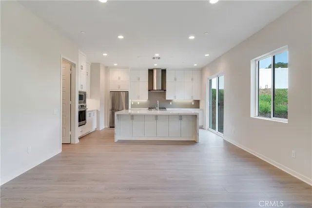 a large white kitchen with a large window
