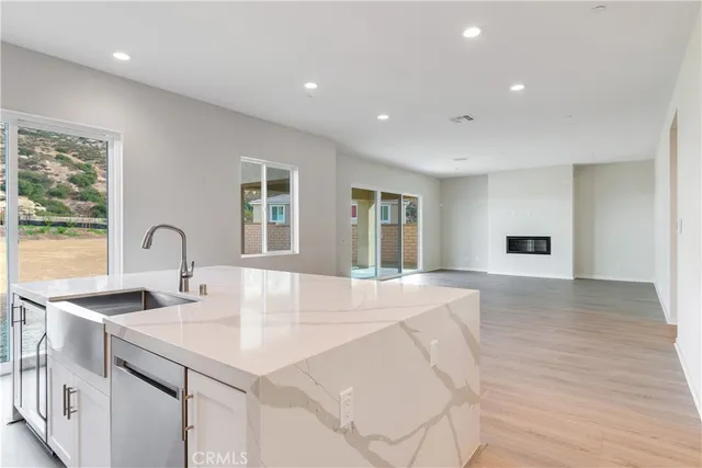 a view of kitchen with a sink and wooden floor