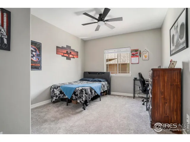 a bedroom with a bed and a desk