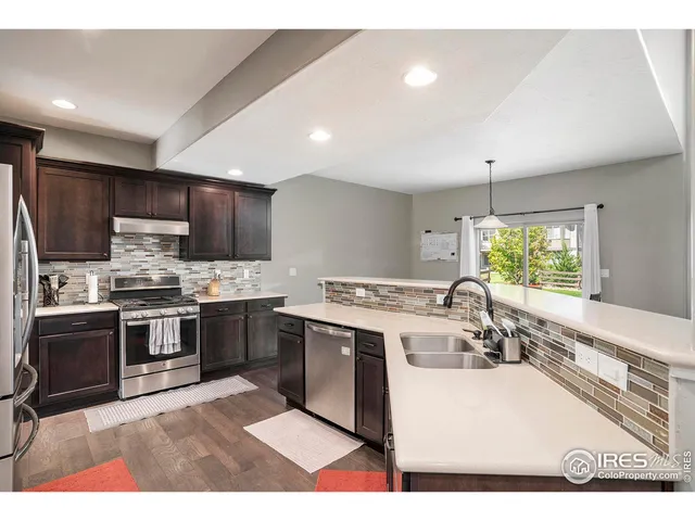 a kitchen with a stove sink and microwave