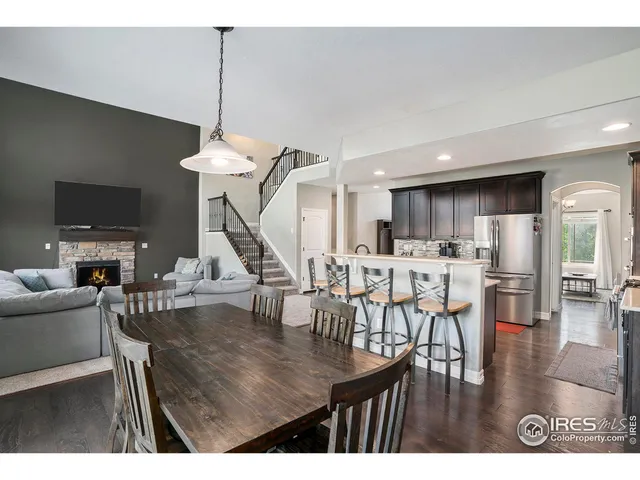 a dining room with furniture and wooden floor