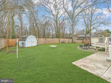 a view of a house with backyard and a tree