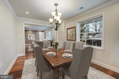 a view of a dining room with furniture wooden floor and chandelier