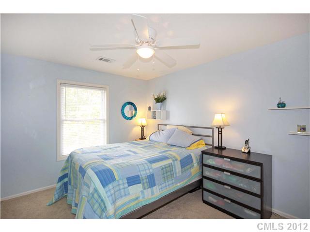 6200 Wright Road Kannapolis, NC 28081 - Photo 11 of 11 a bedroom with a bed a chandelier and a window