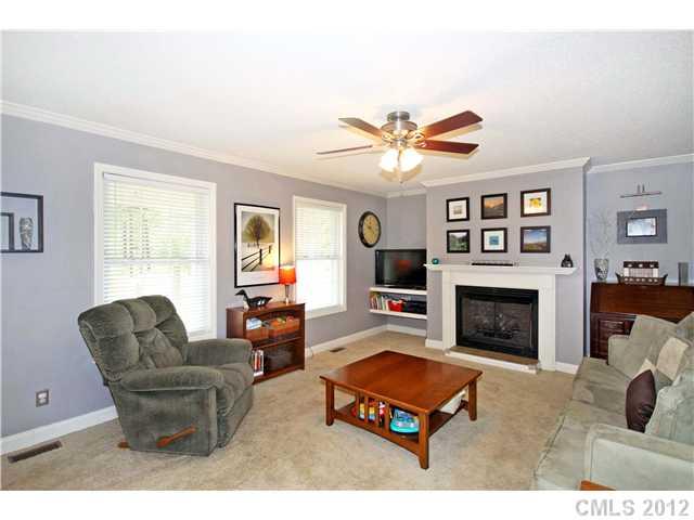6200 Wright Road Kannapolis, NC 28081 - Photo 7 of 11 a living room with furniture a flat screen tv and a fireplace