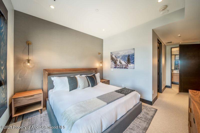 77 Wood Road, Unit 303 Snowmass Village, CO 81615 - Photo 17 of 43 a bedroom with a bed and a walk in closet