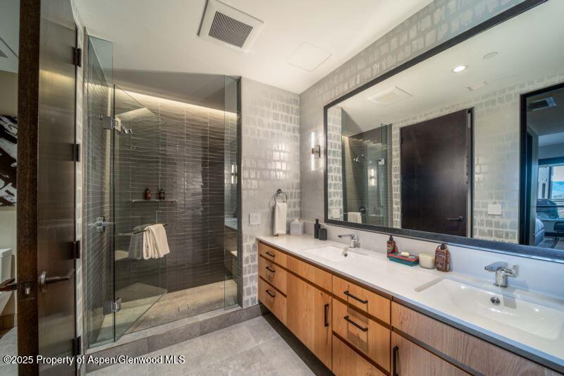 77 Wood Road, Unit 303 Snowmass Village, CO 81615 - Photo 20 of 43 a bathroom with double vanity and a shower