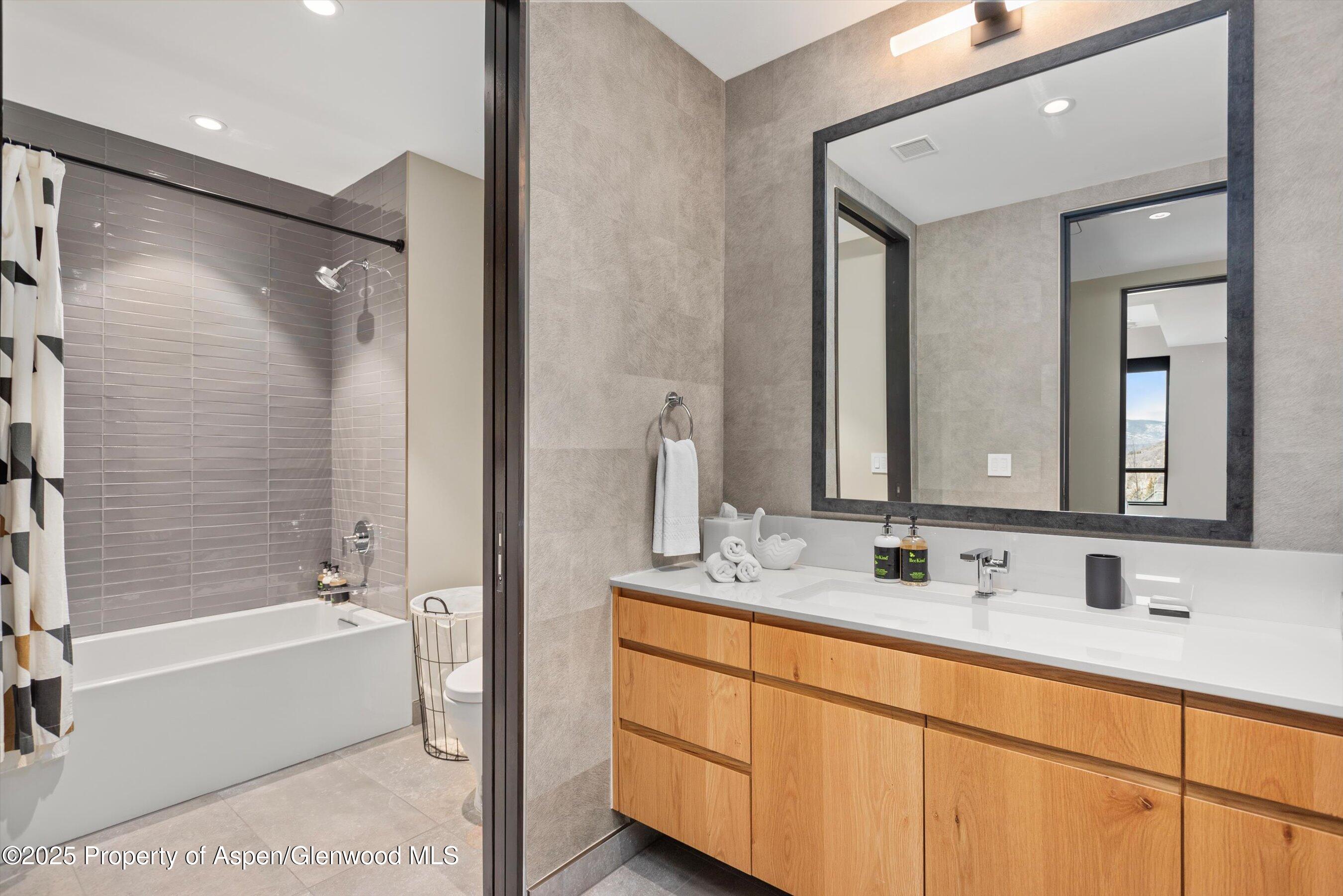 77 Wood Road, Unit 303 Snowmass Village, CO 81615 - Photo 24 of 43 a bathroom with a double vanity sink mirror double and bathtub