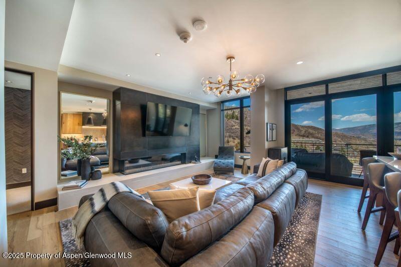 77 Wood Road, Unit 303 Snowmass Village, CO 81615 - Photo 3 of 43 a living room with furniture a flat screen tv and a large window