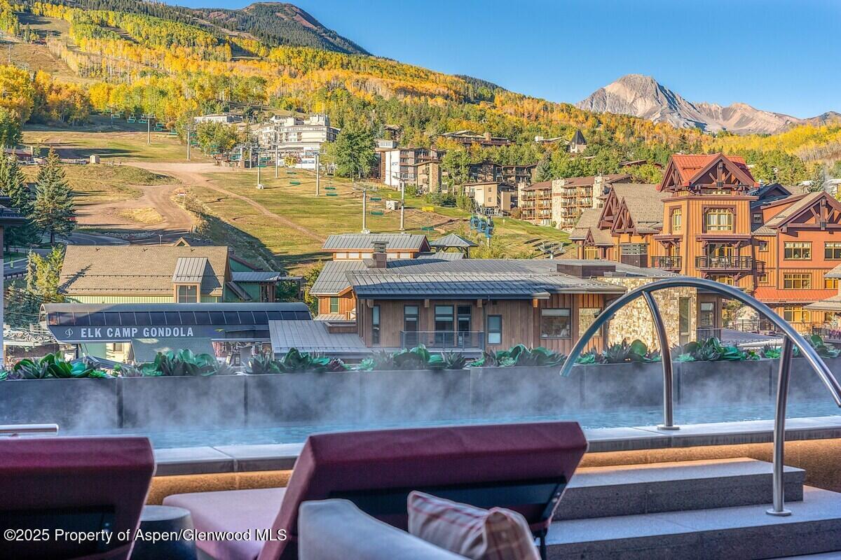 77 Wood Road, Unit 303 Snowmass Village, CO 81615 - Photo 33 of 43 a backyard of a house with table and chairs