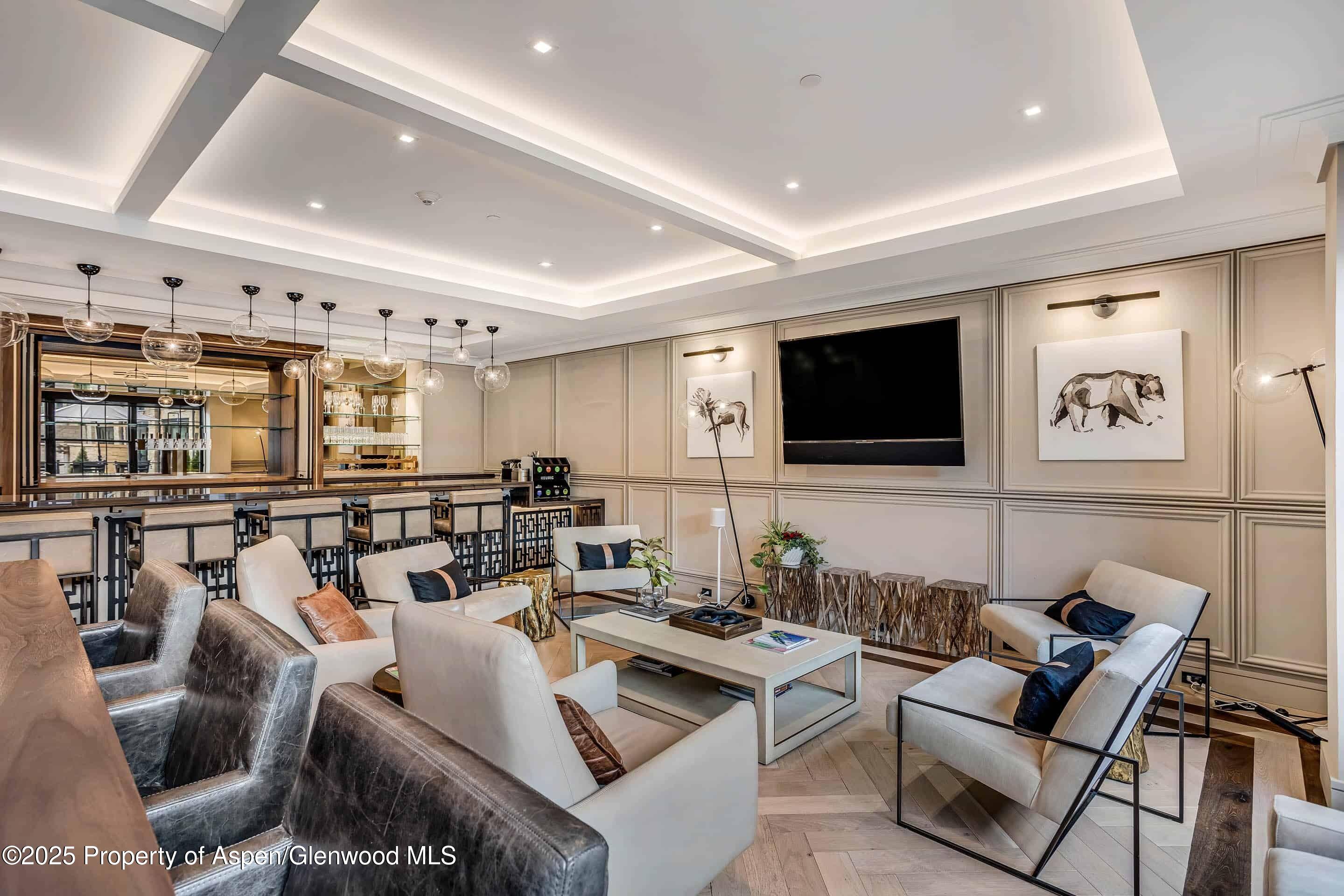 77 Wood Road, Unit 303 Snowmass Village, CO 81615 - Photo 38 of 43 a living room with furniture kitchen view and a flat screen tv