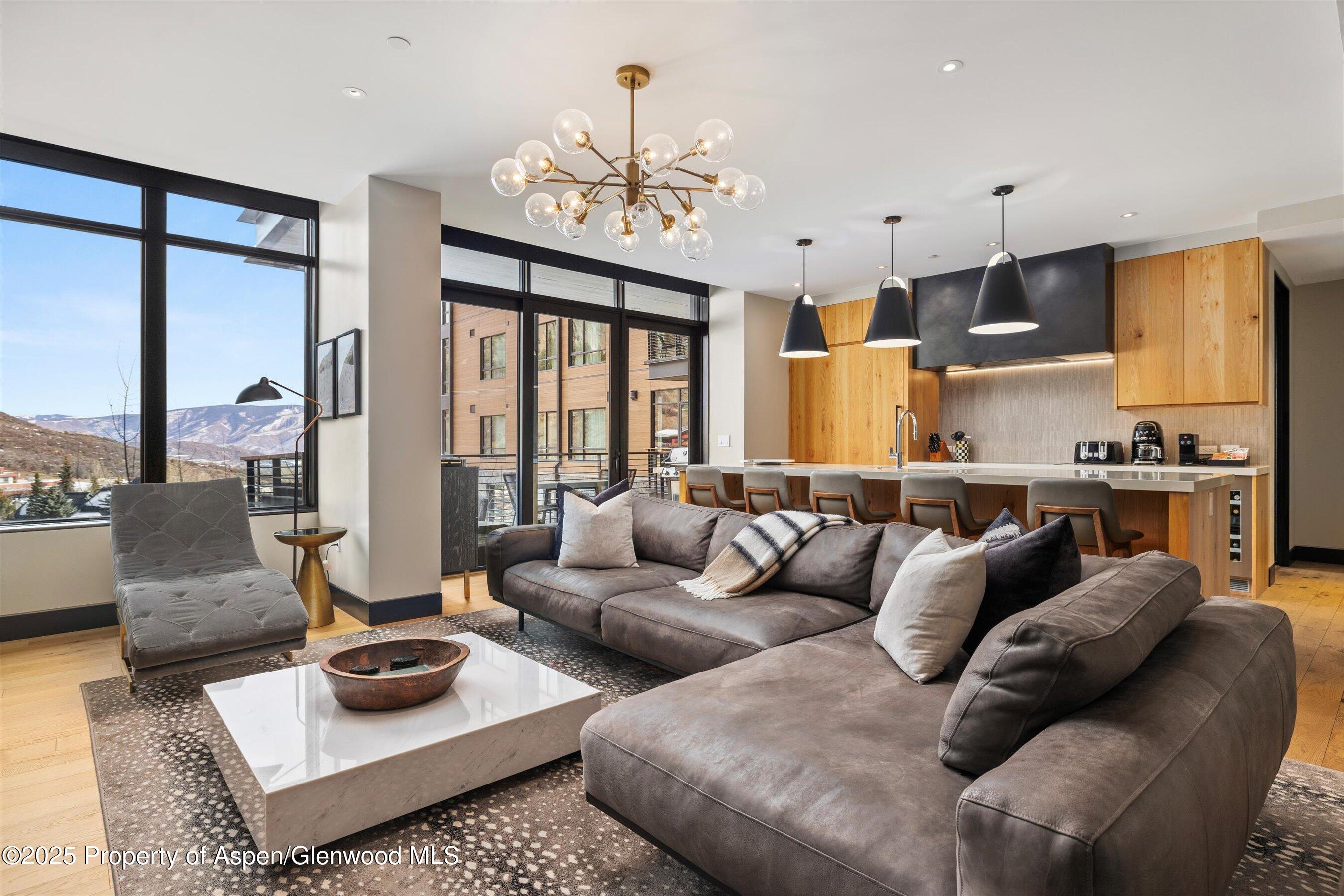 77 Wood Road, Unit 303 Snowmass Village, CO 81615 - Photo 4 of 43 a living room with furniture and a chandelier