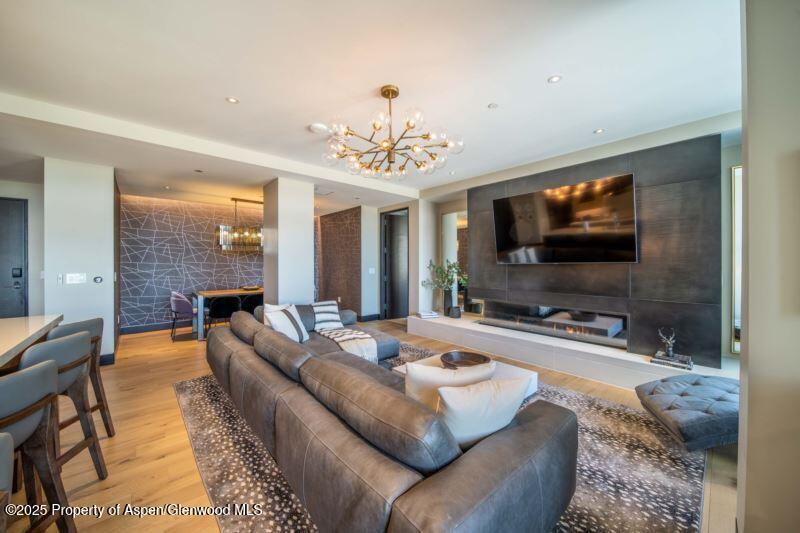 77 Wood Road, Unit 303 Snowmass Village, CO 81615 - Photo 6 of 43 a living room with furniture and a flat screen tv