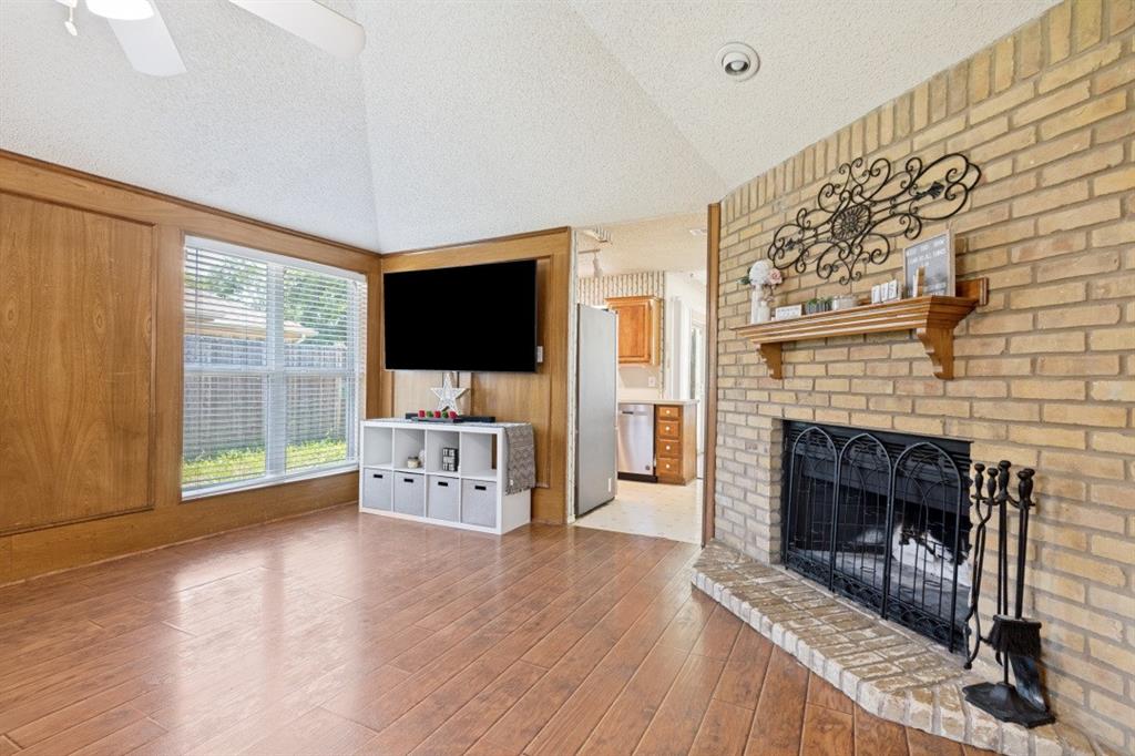 7410 Jessica Way Rowlett, TX 75088 - Photo 9 of 25 a living room with furniture a flat screen tv and a fireplace