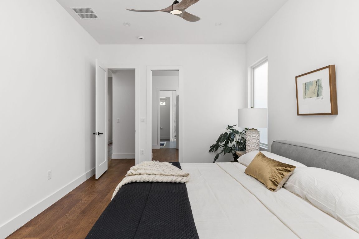 127 Frederick Street Austin, TX 78704 - Photo 15 of 35 a bedroom with a bed and wooden floor