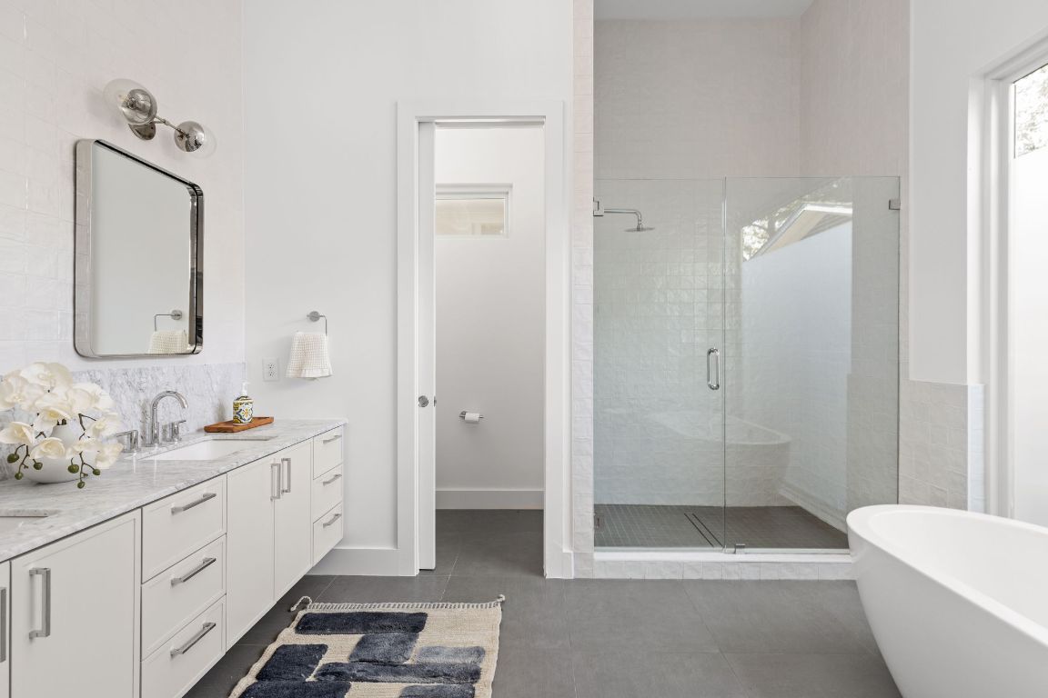 127 Frederick Street Austin, TX 78704 - Photo 17 of 35 a bathroom with a double vanity sink mirror and bathtub